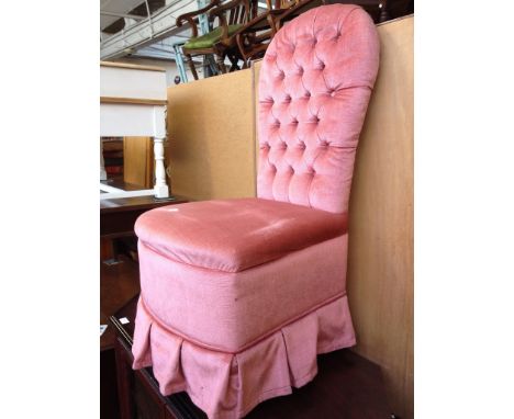 A SALMON COLOURED BUTTON BACK NURSING CHAIR