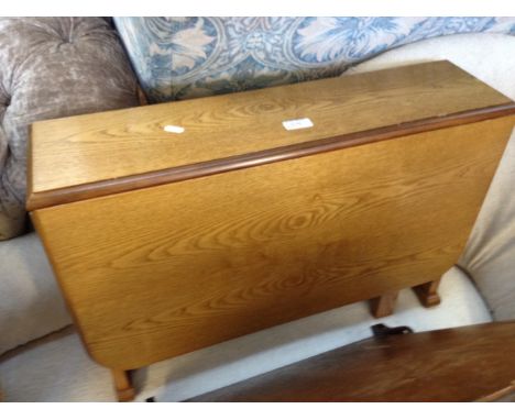 A SMALL LIGHT OAK DROP LEAF TABLE