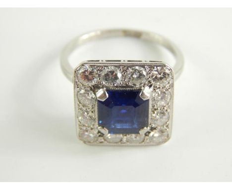 An Art Deco style sapphire and diamond ring, of square design, with central square cut sapphire, 8mm 8mm x 4.2mm, approx 2.23