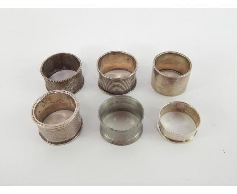 Six Victorian and later silver napkin rings, one with engraved foliate decoration, two with engine turned decoration and thre