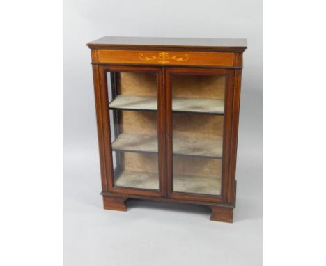 An Edwardian mahogany and inlaid display cabinet, with two glazed doors enclosing two shelves, raised on bracket feet, 74cm x