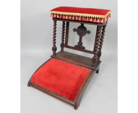 A Victorian oak prie dieu, the lift up arm rest opening to reveal a book compartment, raised on spiral wrist supports with cr
