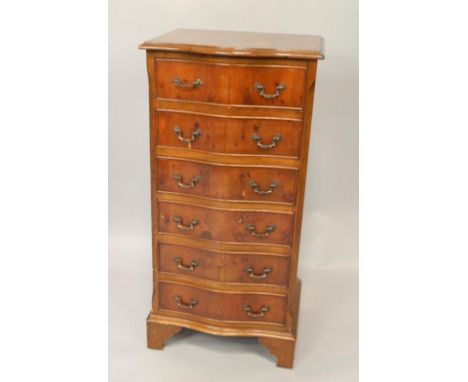 A yew wood serpentine chest of six drawers, raised on bracket feet, 48.5cm x 40cm x 99cm.