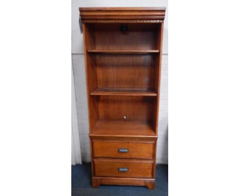 An Ashley oak display cabinet, the cornice with dentil moulding, an inset light, over two partial glass inset drawers, over t