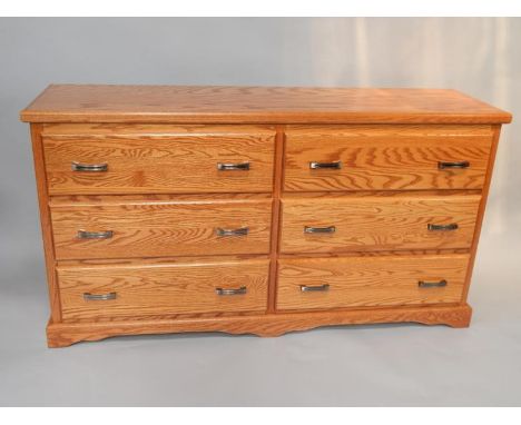 A P M Amish oak chest, of six long drawers, raised on a bracket base, 156cm x 43.5cm x 84cm.