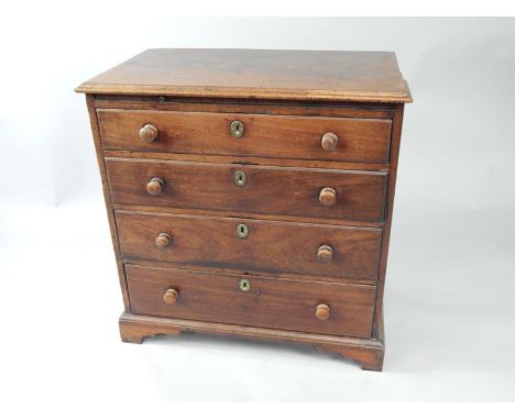 A George III mahogany bachelor's chest of drawers, with brushing slide over four long graduated drawers, raised on bracket fe