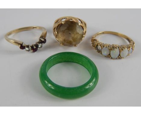 A 9ct gold and smokey quartz ring, high claw set, size G, 9ct gold and opal fire stone ring, one stone lacking, size O, 9ct g