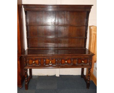 A 19thC oak Carolean style dresser, the three shelf Delft rack over two drawers, raised on baluster supports united by stretc