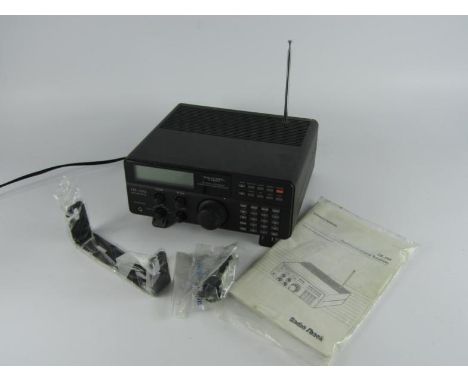 A Radio Shack DX-394 General Coverage Communications Receiver, AM/SSB/CW, with mounting bracket and manual.
