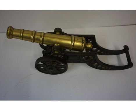 Antique Brass Model of a Cannon, Raised on a tilting iron cart wheel, 18cm high, 47cm long, also with a Victorian edition of 