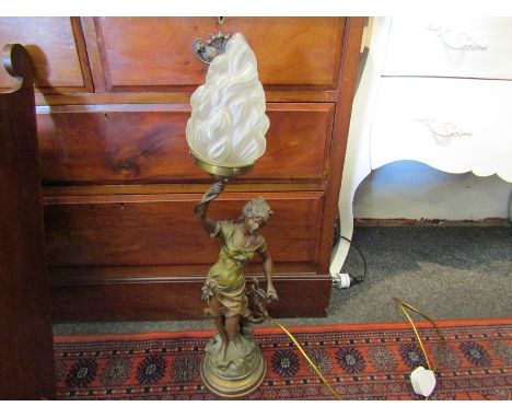 A decorative cast figural lamp with flame form shade