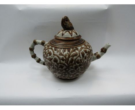 A pottery Islamic style teapot with bird finial lid
