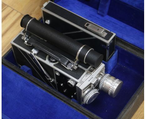 A Cine-Kodak Special II camera with accessories and travel case.