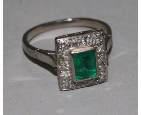 A white gold, emerald and diamond rectangular cluster ring, size I.