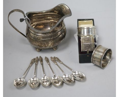 A George III silver cream jug, a Victorian silver napkin ring (cased), two other napkin rings and a set of six silver apostle