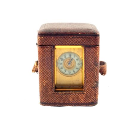 A miniature gilt metal carriage clock with porcelain dial in original case