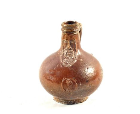 A rare 17th Century small Bellarmine salt glazed jug with a bearded mask above a small portrait medallion 