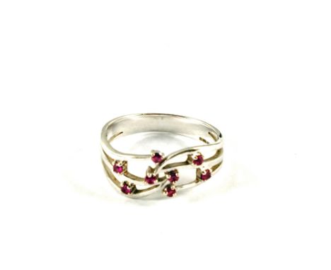 A 9ct White Gold ring set with eight small red stones, size R