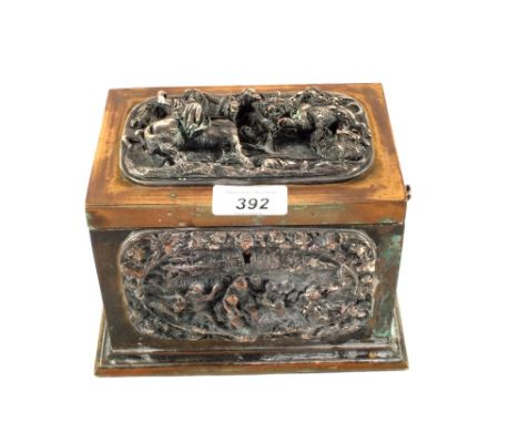 A 19th Century Brass two compartment tea caddy with applied electrotypes of cupids and figures, the lid with a high relief Si