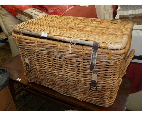 A vintage Cane Laundry Basket having leather fastening strap and two cane carrying handles, 32'' x 18 1/2'' x 18'' high appro