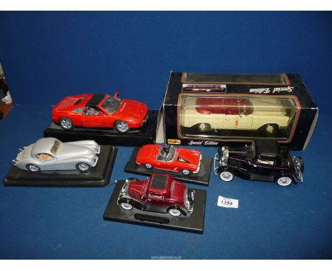 Six large scale model cars including Burago Jaguar XK120, Ferrari, etc.