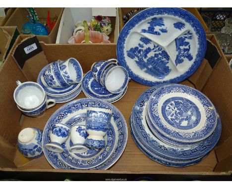A quantity of blue and white willow pattern china including cups, saucers, tea and dinner plates, Masons Goose egg cup, etc. 