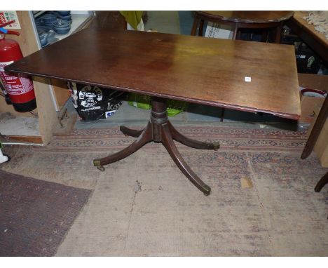 A period snap top table having a turned pillar with four swept feet terminating in brass capped castors, the top being a leaf