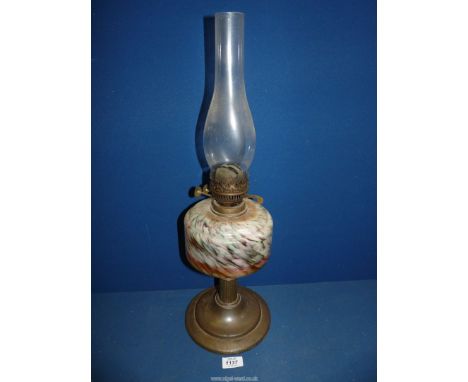 An Oil lamp with mottled colour glass reservoir and metal base.