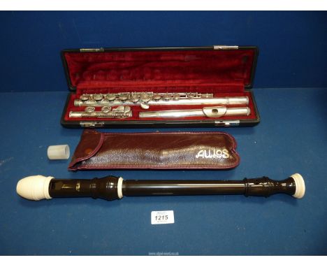 A cased Yamaha Flute and a cased Aulos recorder.