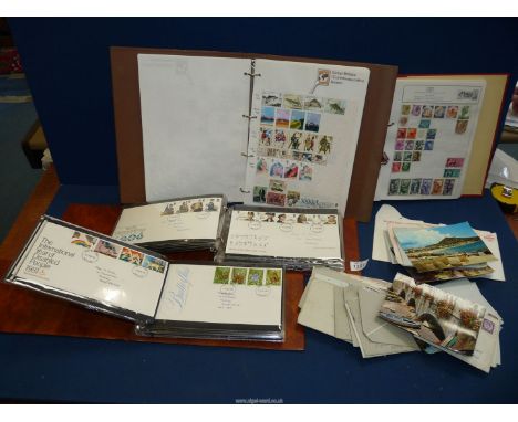 A quantity of First Day Covers including 'British textiles', 'The British Army' etc plus some stamp albums (mostly empty).