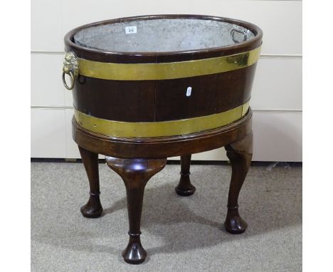 An 18th century brass-bound walnut oval wine cooler, with brass lion-ring handles and cabriole legs, width 23", height 24" 