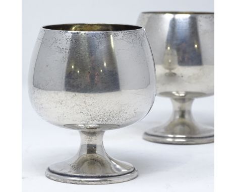 A pair of 1970s silver brandy goblets, of plain form with gilt interior, by A T Cannon Ltd, hallmarks Birmingham 1978, height