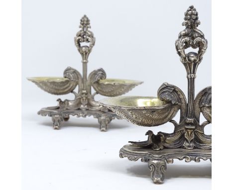 A pair of 19th century cast French silver Rococo style table salts, with gilt shell design bowls and dolphin supports, stampe