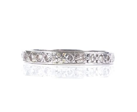 An unmarked white metal diamond eternity ring, total diamond content approx 0.5ct, band width 2.9mm, size R, 3.1g 