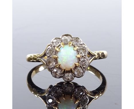 An unmarked gold cabochon opal and diamond cluster ring, setting height 11.3mm, size O, 3.3g 