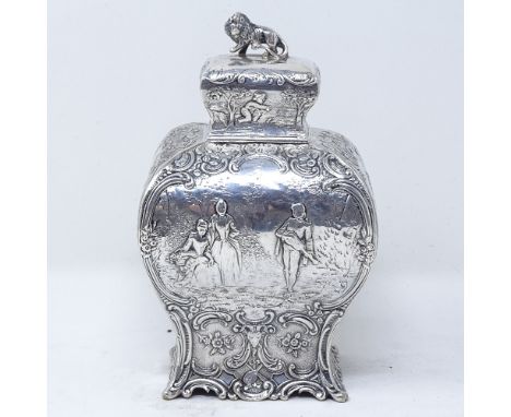 A 19th century French silver tea caddy, of rectangular baluster form, with relief embossed lover scenes, within a foliate and
