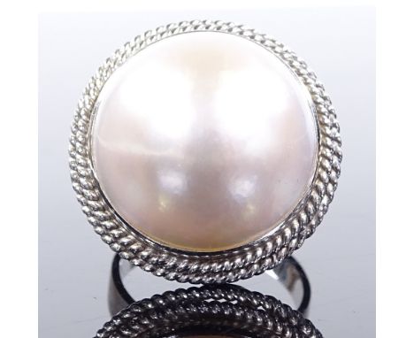 An 18ct white gold Mikimoto mabe pearl panel ring, with rope twist surround and pierced under bridge, setting height 22.4mm, 