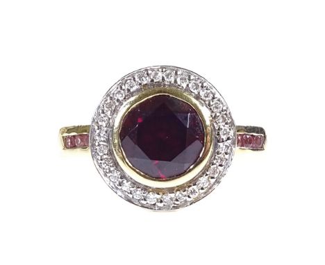 An 18ct gold garnet and diamond cluster ring, with pink tourmaline shoulders, setting height 13.2mm, size N, 6.5g 