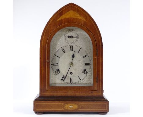 An Edwardian mahogany and marquetry inlaid lancet-top mantel clock, with engraved silvered dial and 8-day chiming movement, h