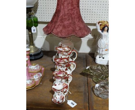 A Graduated Set Of Four Masons Mandalay Red Pattern Milk Jugs Together With A Similar Table Lamp