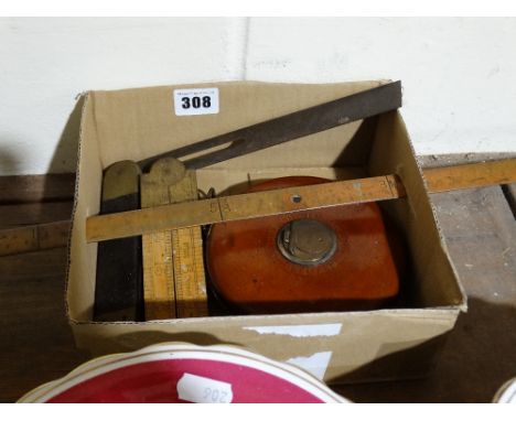 A Stitched Leather Encased Surveyors Tape Together With A Quantity Of Vintage Rules