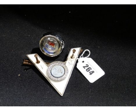 A Vintage Automobile Badge Together With A Morris Gear Stick Knob