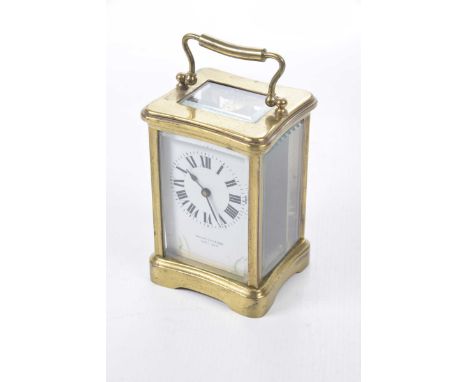 A late 19th Century brass case carriage clock, retailed by Wheatley & Son, CarlisleThe corniche full brass case with white en