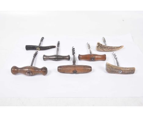 A collection of various vintage corkscrews 
To include three wooden turned examples and a metal turned example and three antl