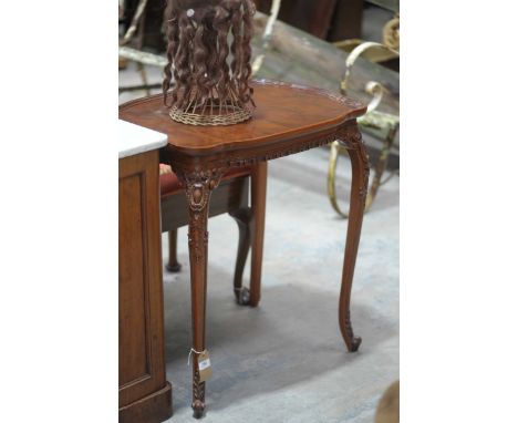 A Chippendale style walnut occasional tableThe shaped top with a moulded border raised upon slender carved cabriole legs with