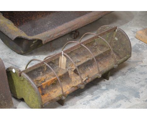 A vintage cast iron pig feeding troughthe ten section twin gully trough raised on trestle type supports, 79cm long.