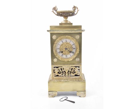 A late 19th Century French gilt metal mantel clockThe slender architectural case raised on foliate bracket feet with pierced 