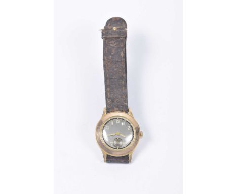 An early 20th century 9k gold manual wind wristwatchWith a black dial and Arabic numerals, to a leather strap, case diameter 