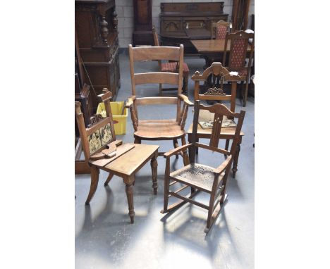 A 19th Century beechwood Windsor chairWith a ladder back above outswept arms supported on turned spindles above a shaped seat