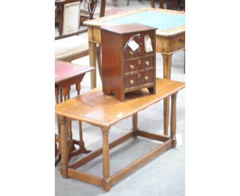 A small mahogany chest of four drawers Each drawer applied with brass button handles along with a modern oak coffee table, ra